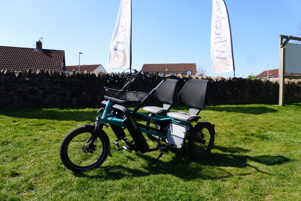 A blue side-by-side tandem cycle